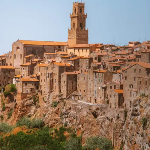 the etruscan hilltop city of pitigliano in italy with houses carved into the cliff face