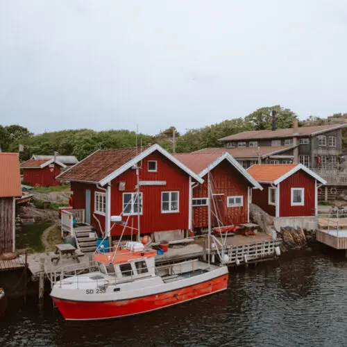Boat houses and a fishing boat at a harbour on North Koster