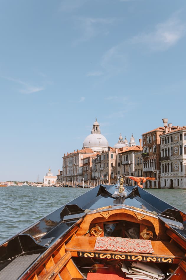 a gondola on the venice canals looking over the grand canal towards the Basilica di Santa Maria della Salute