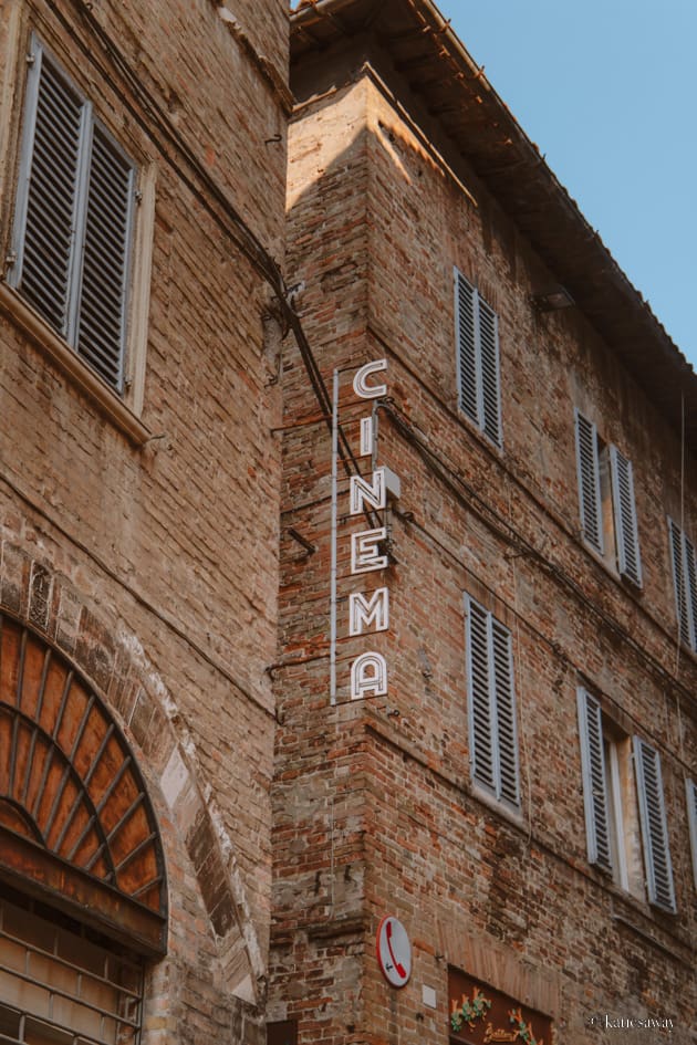 neon sign for the cinema in the centre of urbino in italy