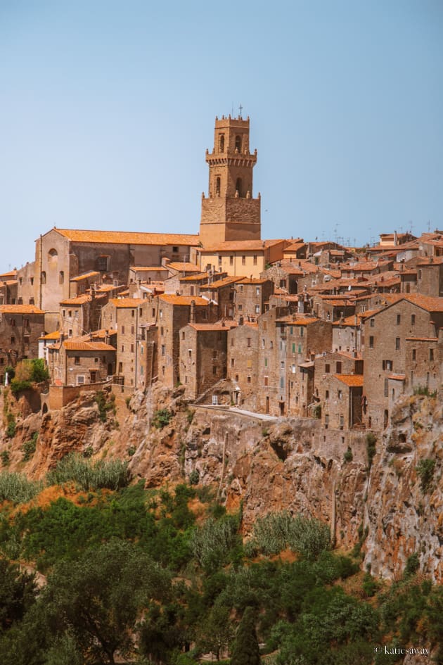 the etruscan hilltop city of pitigliano in italy with houses carved into the cliff face