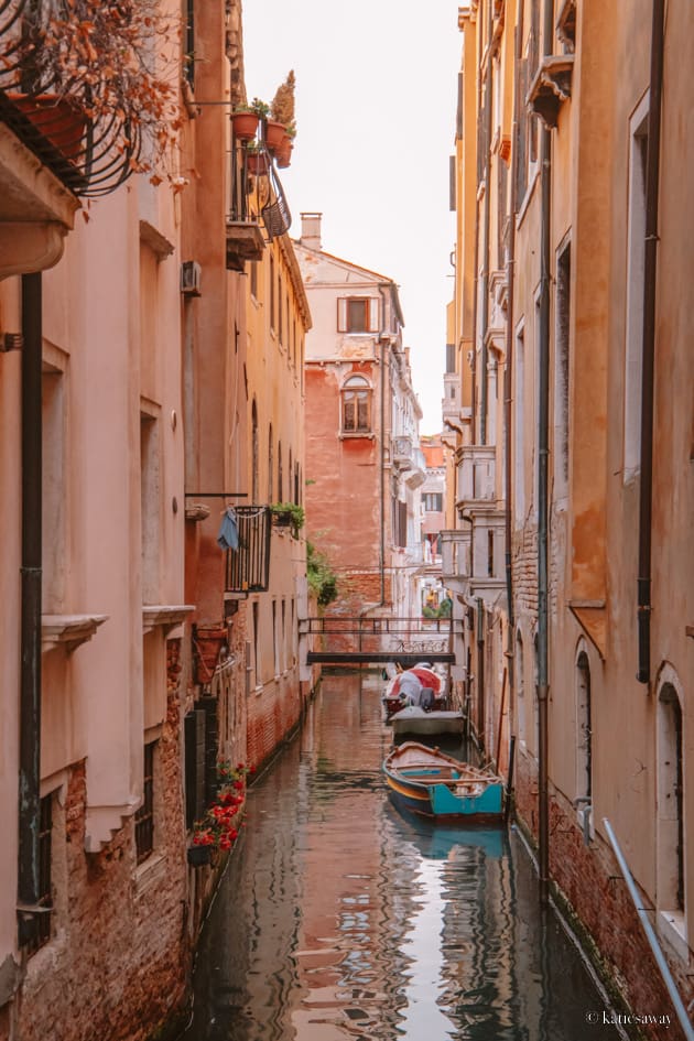 the orange and red houses lining one of venice's canals