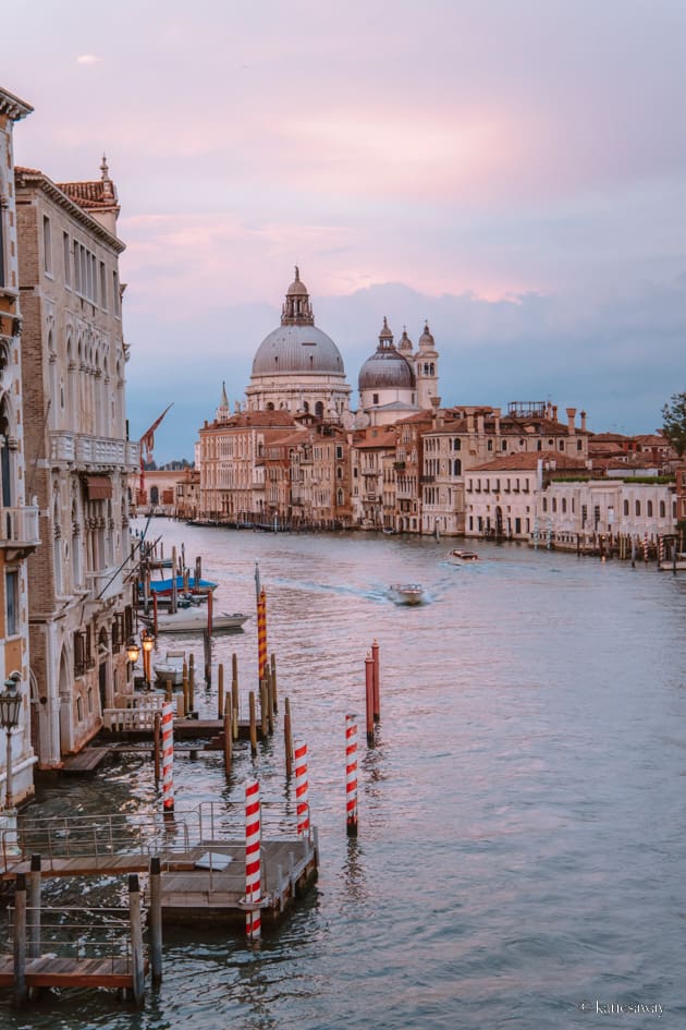 Venice's grand canal at sunset with Basilica di Santa Maria della Salute in the background