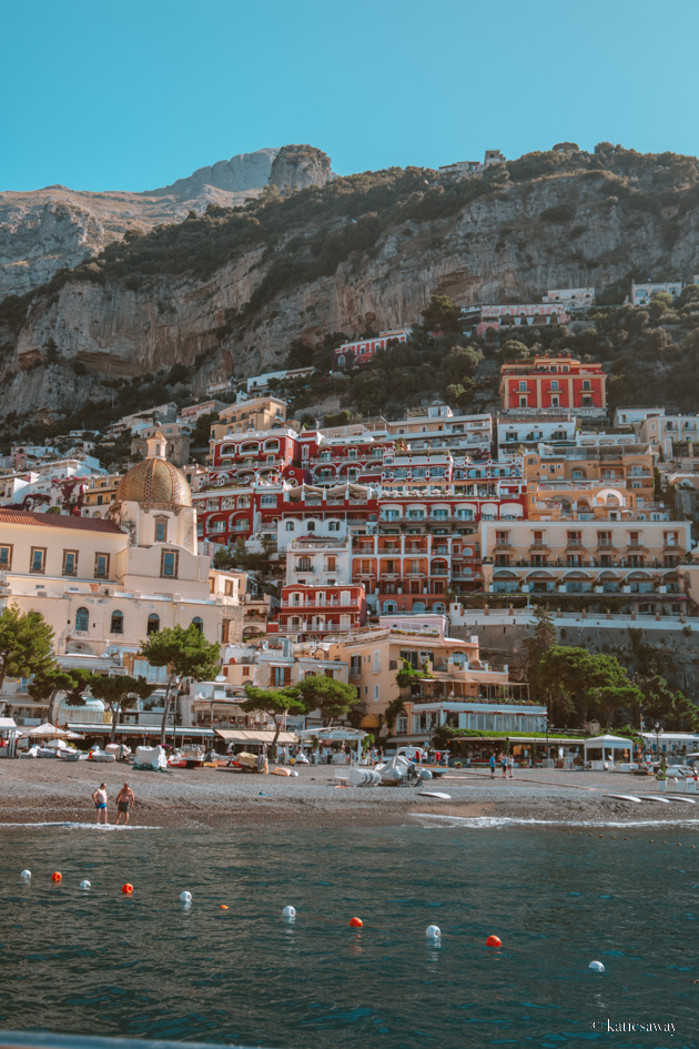 the colourful houses lining the hillside in the town of positano taken from the sea