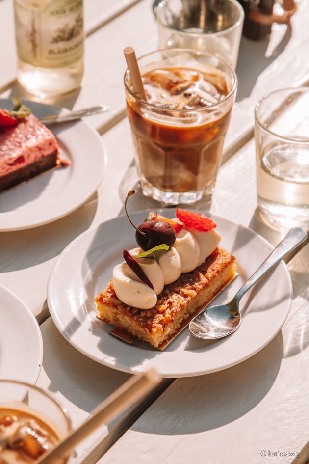 A almond cake with cream and cherries on top from Olof Viktors in Österlen