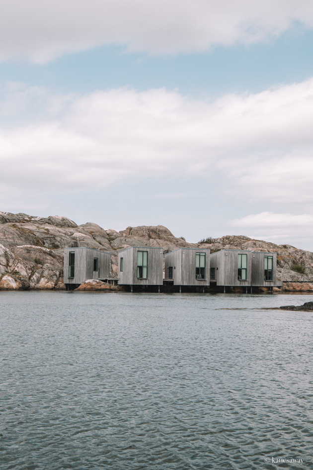 the hotel in klädesholmen that looks like cubes on the water with cliffs behind
