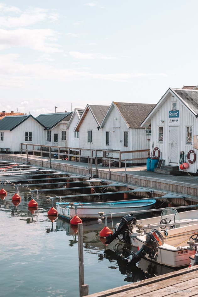 the harbour on Vrångö with white boat sheds and boats lined up in the water