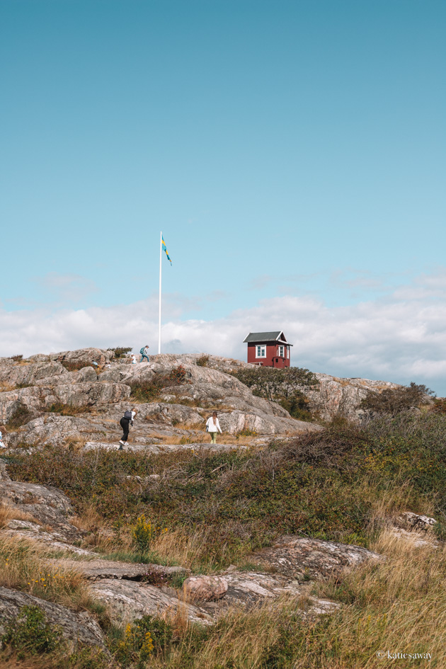 a red house on top of the hill seen from the Södra Slingan Hike Vrångö