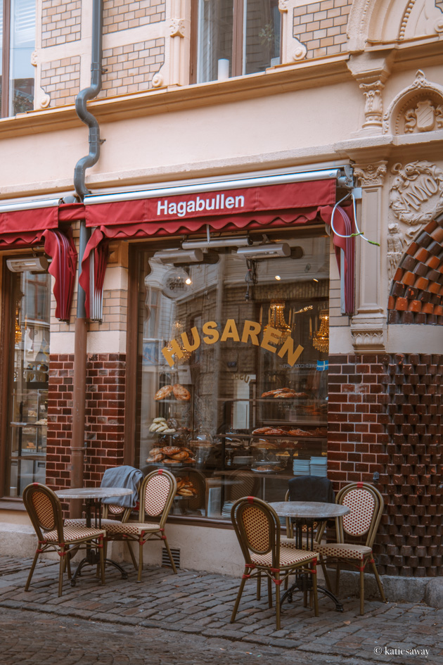 cafe husaren with chairs outside and giant cinnamon buns in the window
