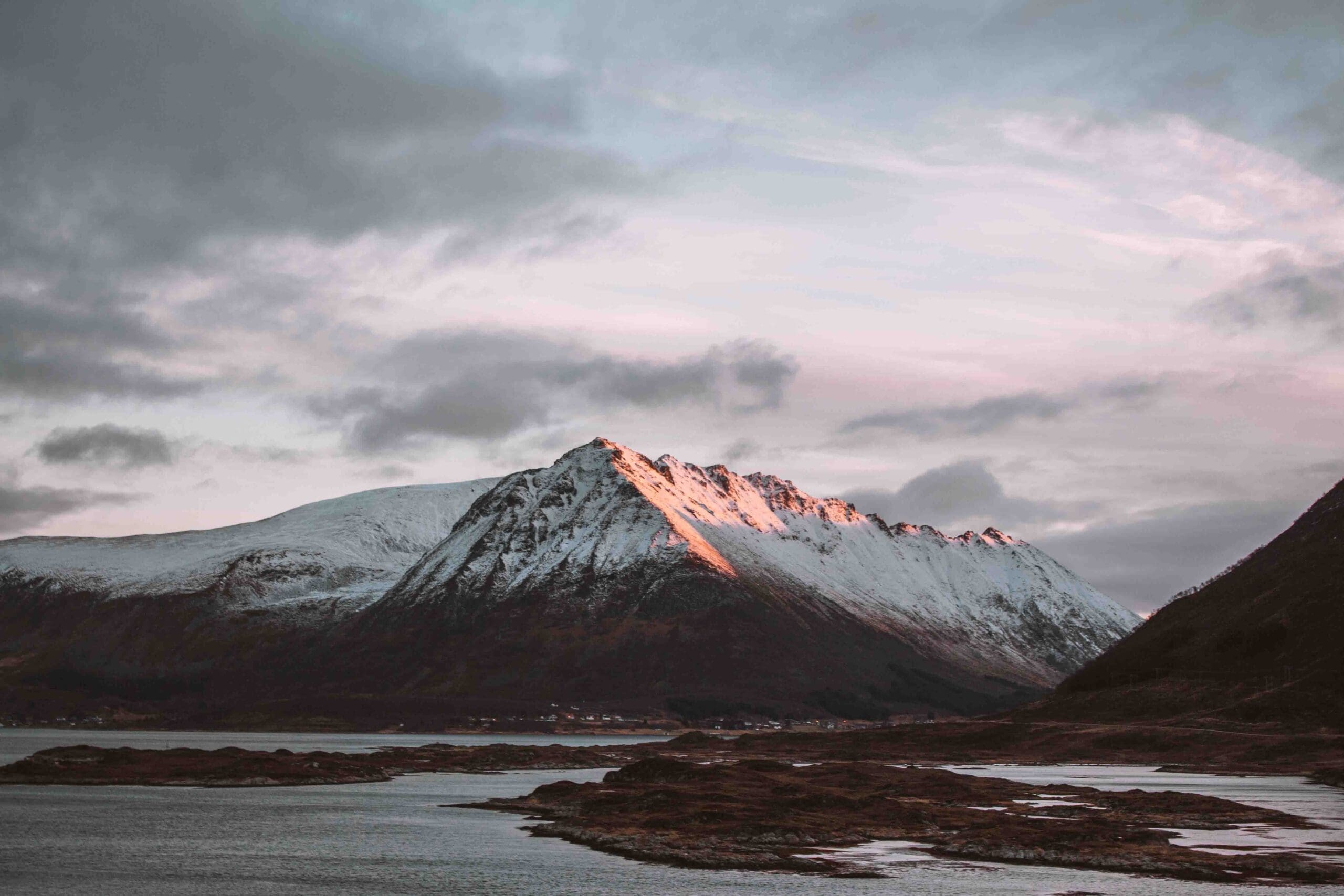 snowy mountain seen from a road on the lofoten islands in winter