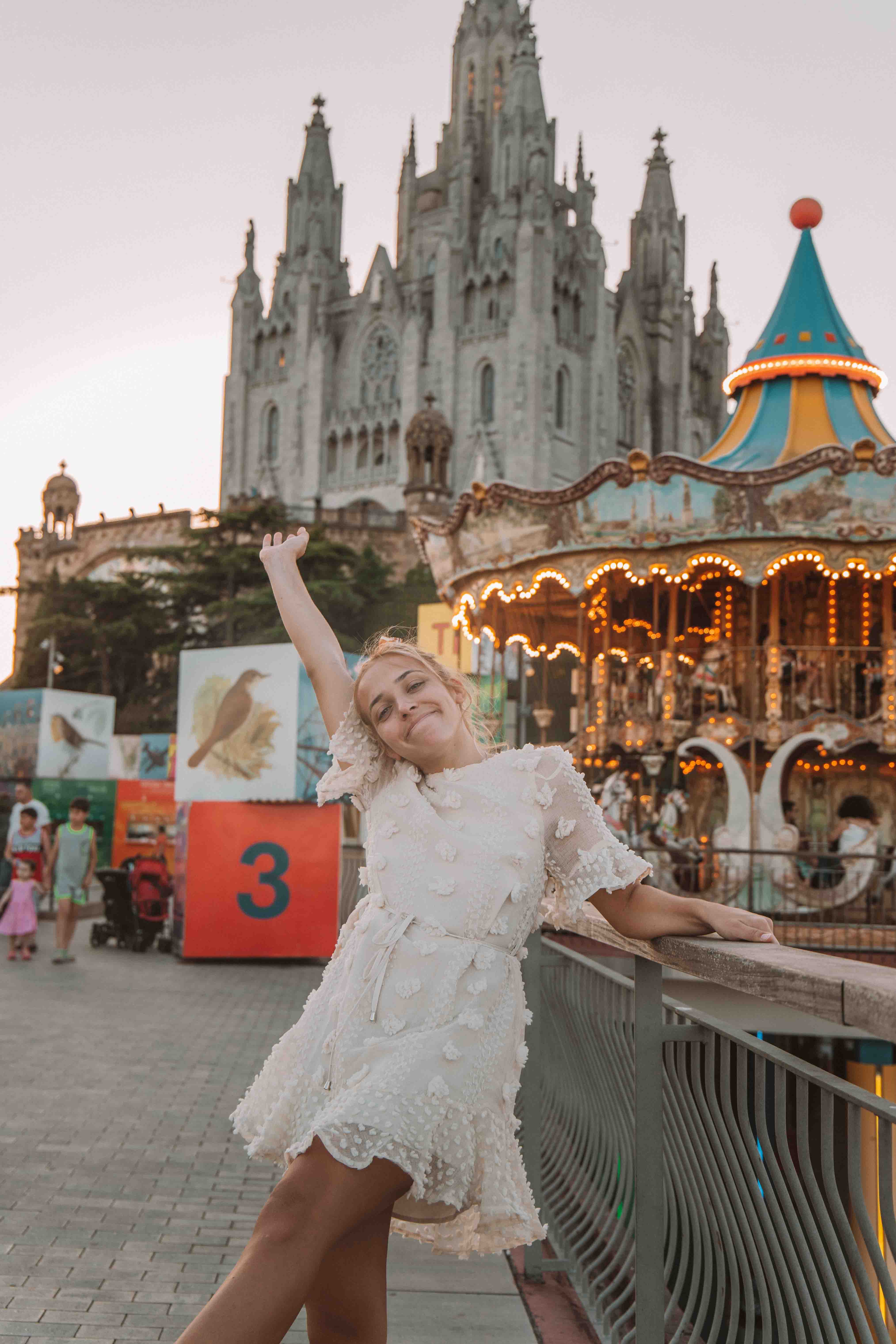 girl in Tibidabo with Temple of the Sacred Heart of Jesus behind