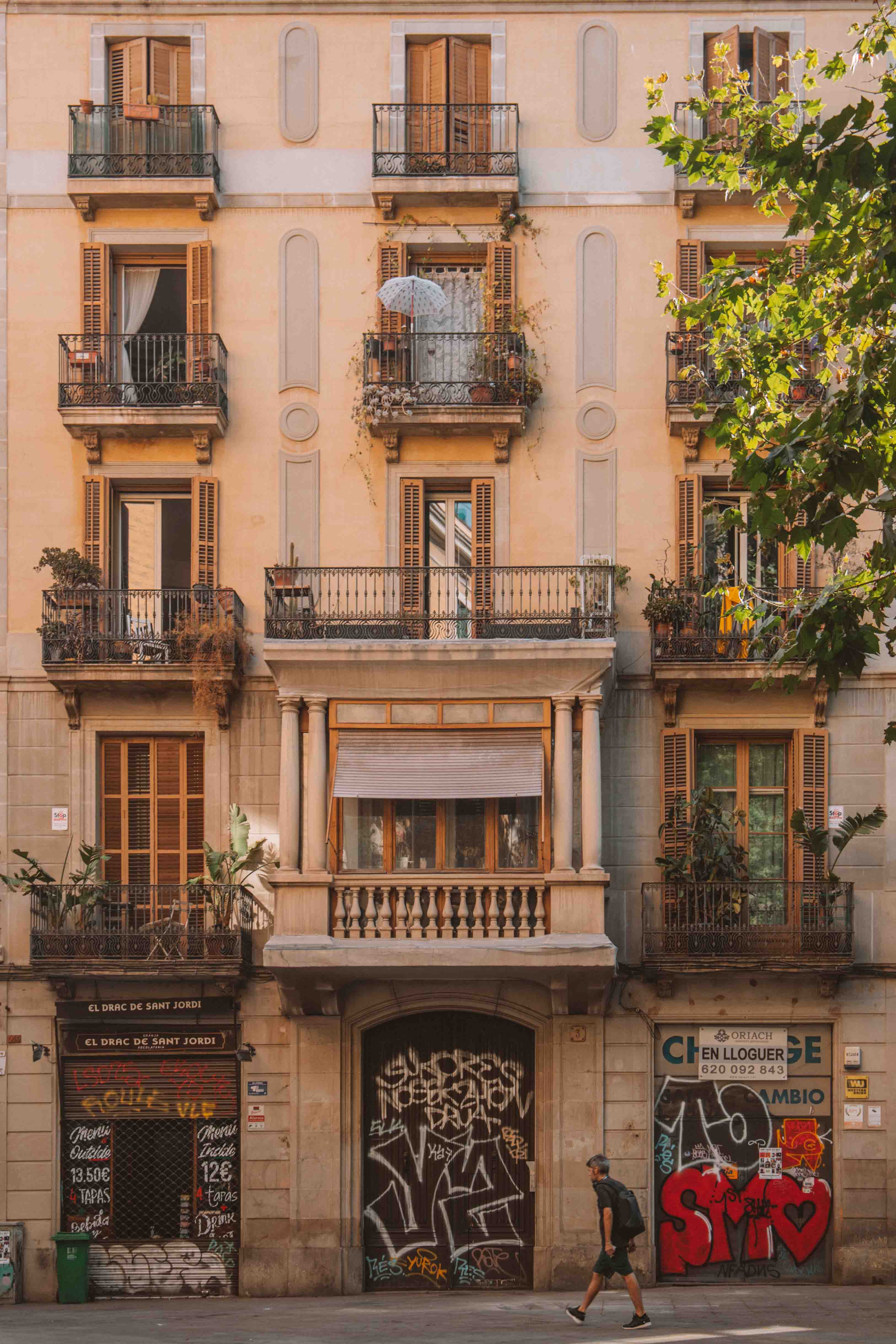 House with balconies and graffitied garage doors in Barcelonas gothic quarter