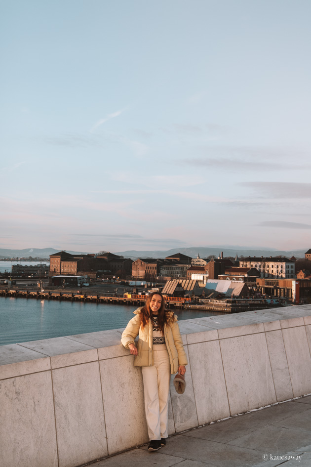 girl stood on the oslo opera house in winter sun with view over the fjord