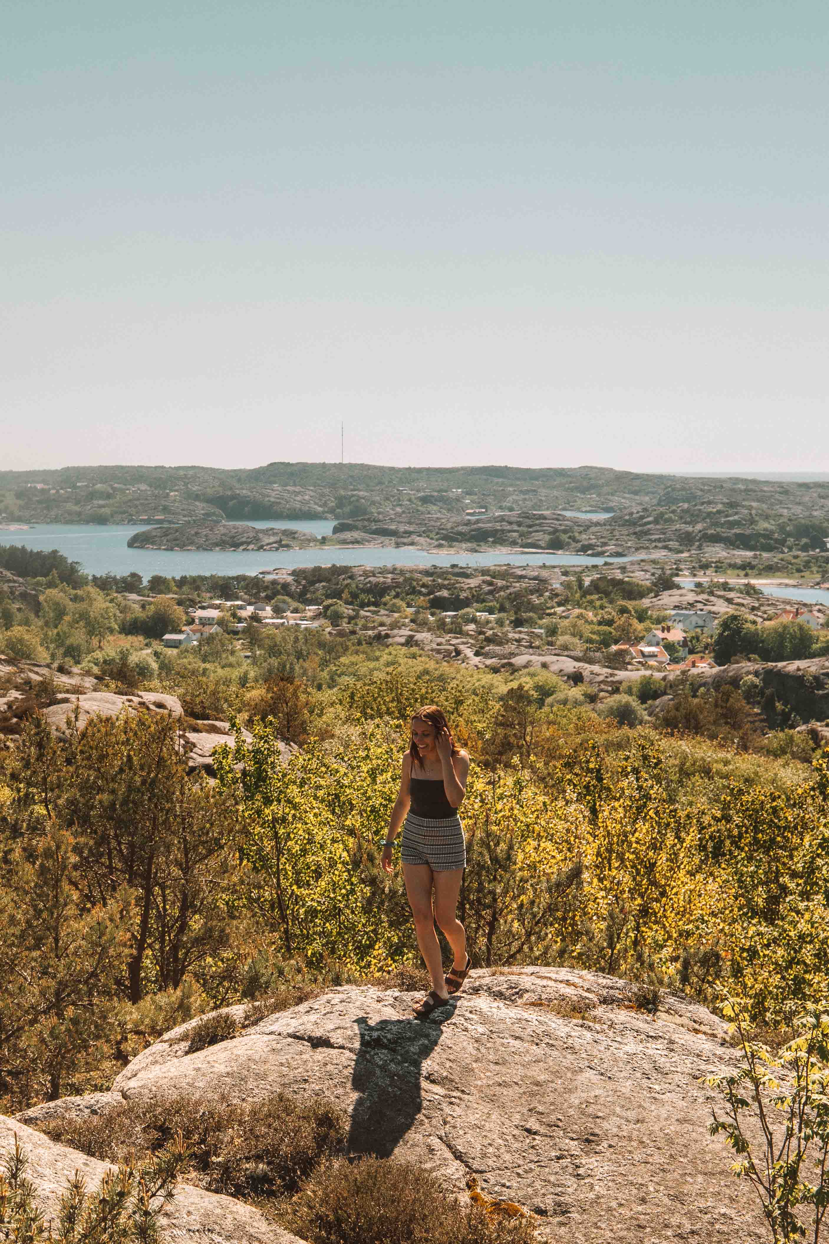 girl standing on rock looking over archipelago outside fjällbacka