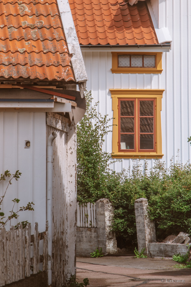 White wooden house with red and yellow windows on Donsö