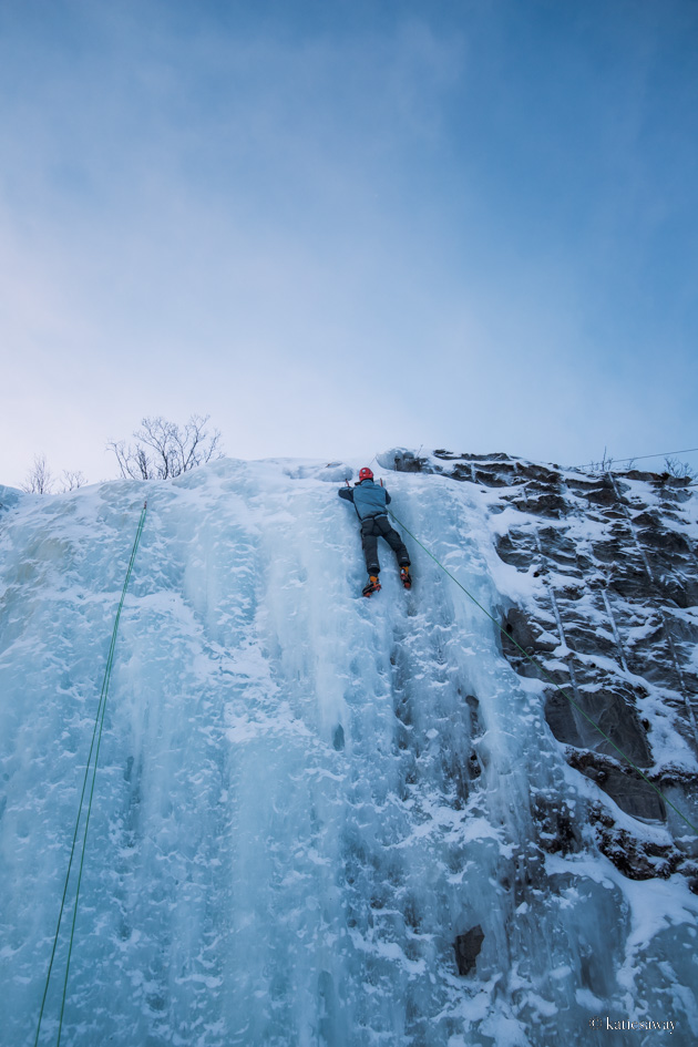 man ice climbing in winter in abisko
