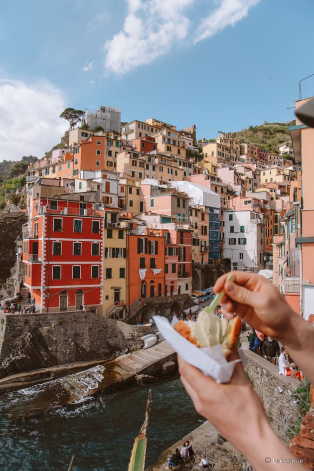 brioche filled iwth pistachio ice cream and riomaggiore harbour in the distance